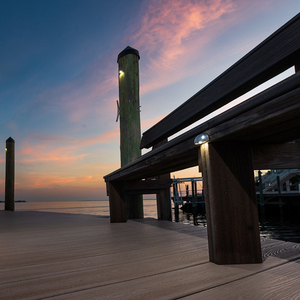 DL15-II Mini Deck Lights mounted on dock posts near the water