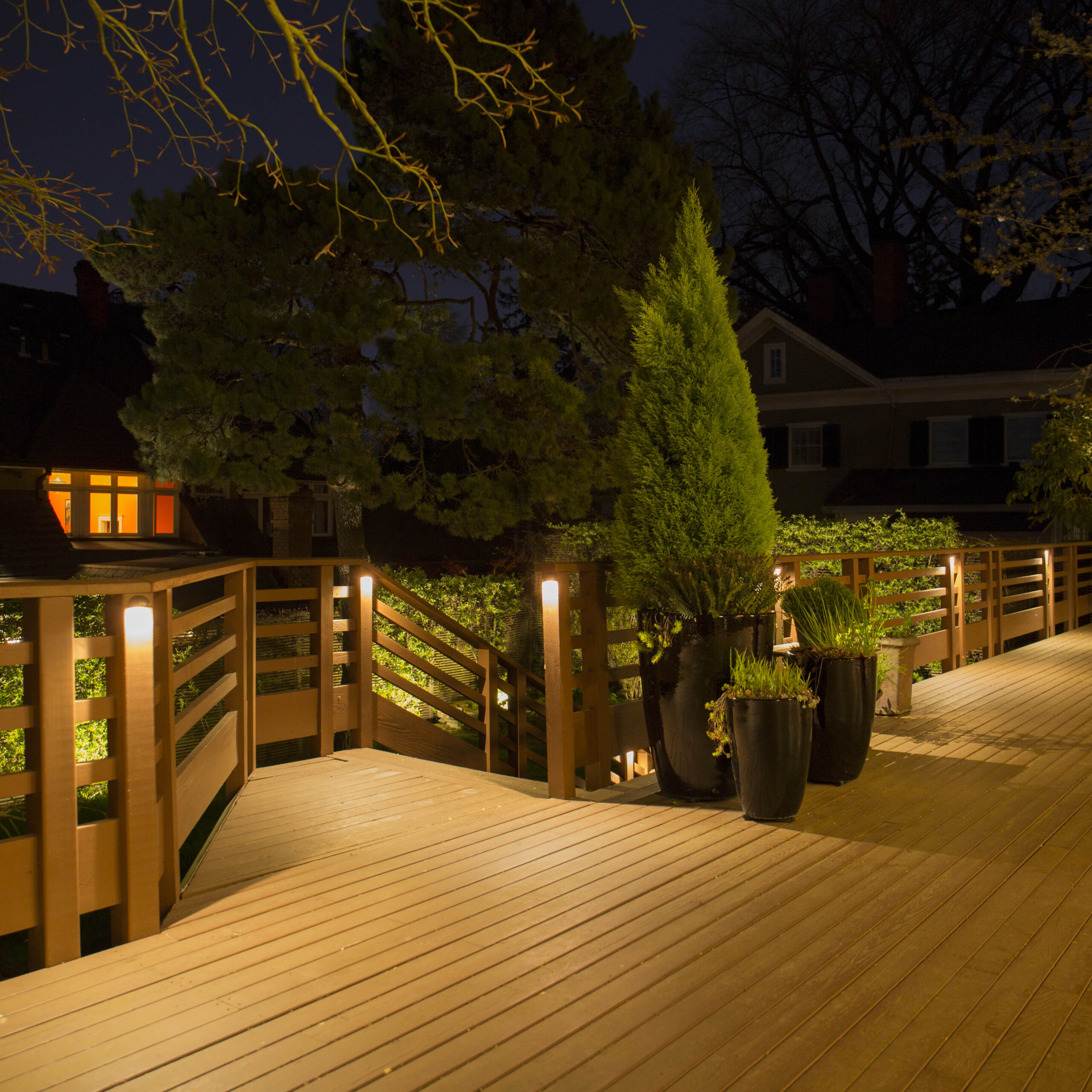 DL15-II Mini Deck Lights illuminating a deck railing and stair area