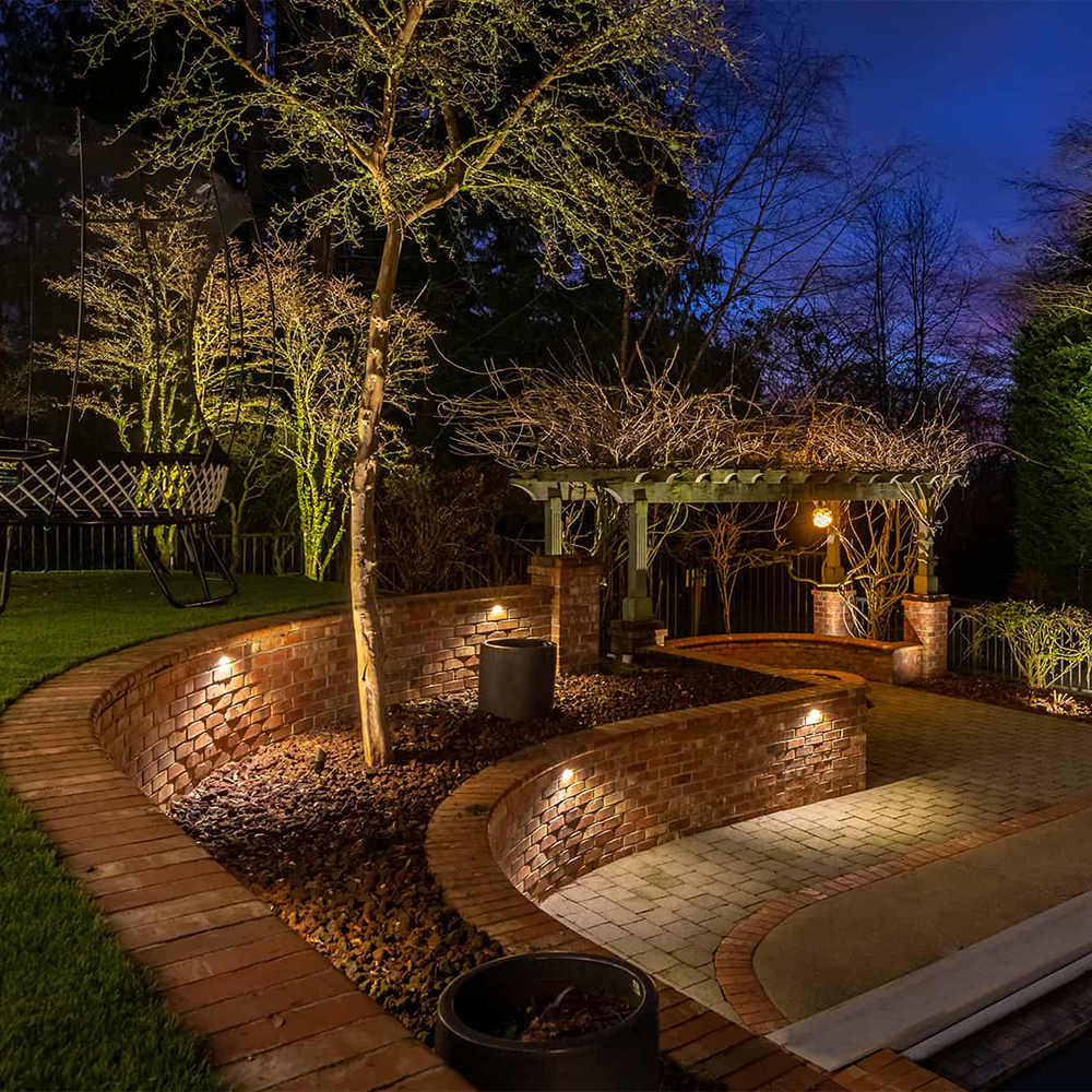 DL15-II Mini Deck Lights installed along curved brick garden walls