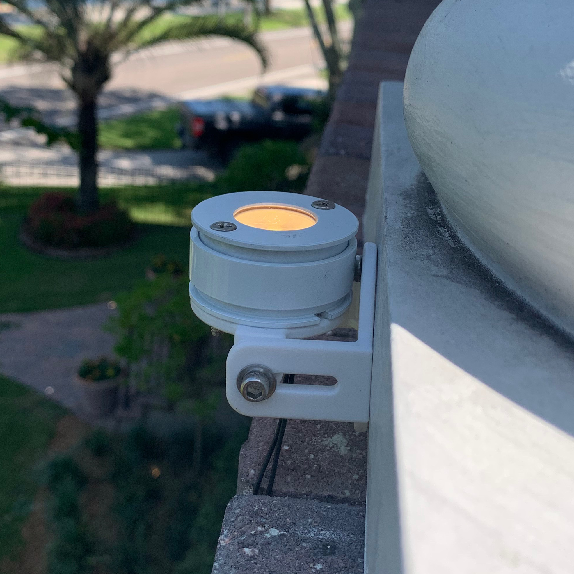 White S1H Saturn Halo mounted to an exterior architectural ledge