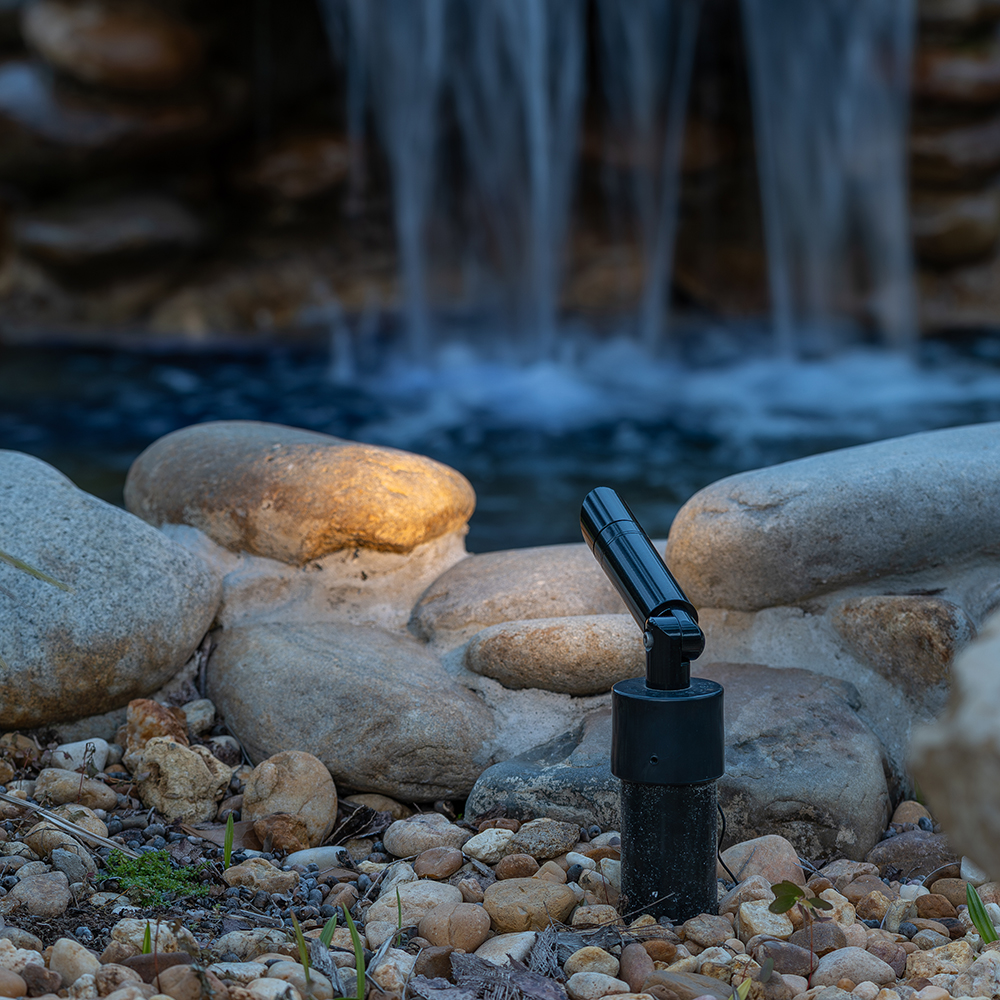 MSL Mini Spotlight with Leg installed near a rock waterfall edge